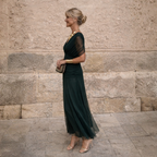 Side profile of the sculpted off-shoulder maxi dress, highlighting the flattering mermaid silhouette.