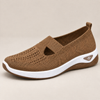 A pair of white sneakers styled with casual jeans, emphasizing their versatile fashion appeal.