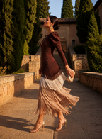 Model posing in the vibrant green layered fringe dress, showcasing its fluid silhouette and midi length.