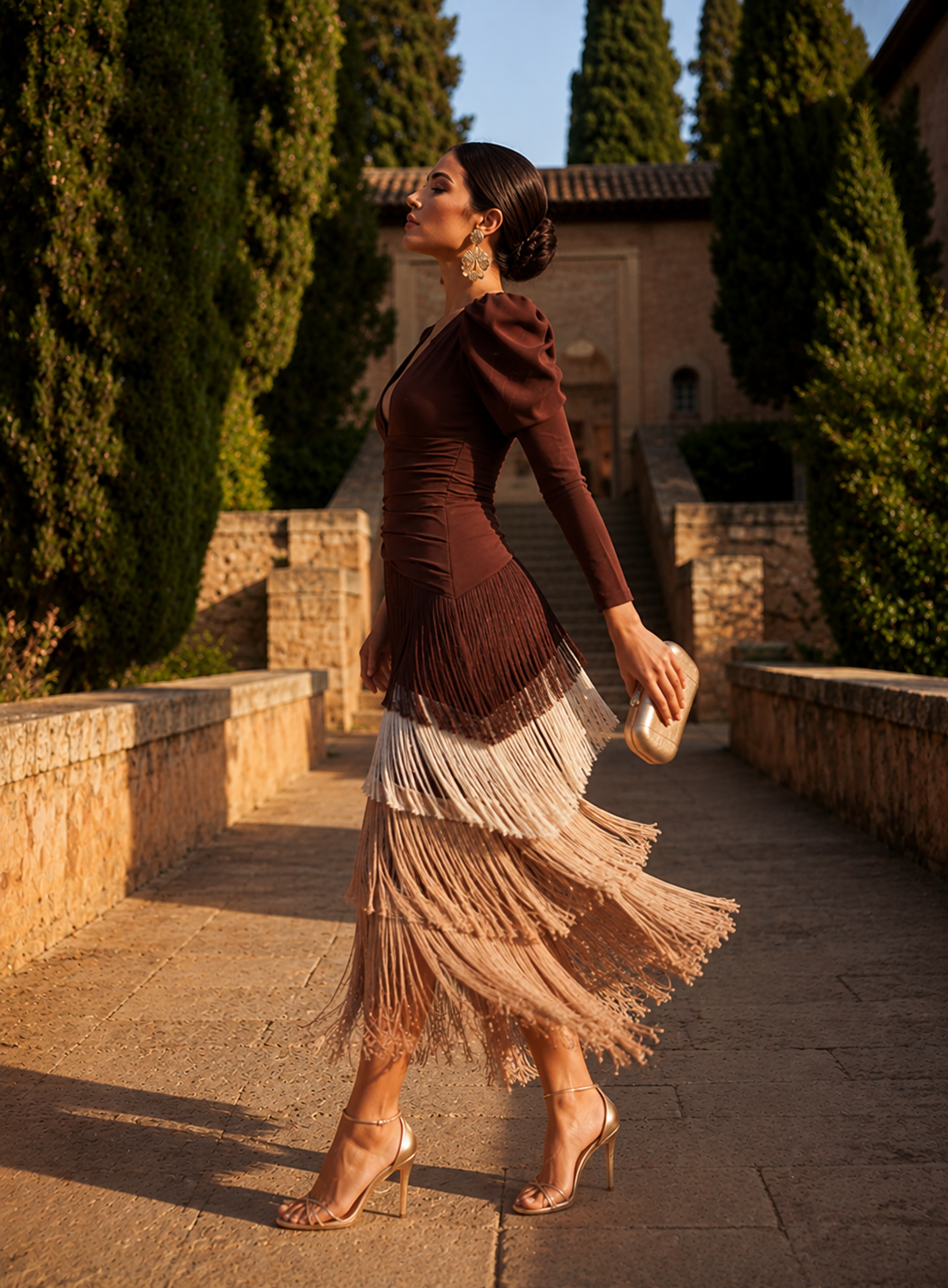 Model posing in the vibrant green layered fringe dress, showcasing its fluid silhouette and midi length.