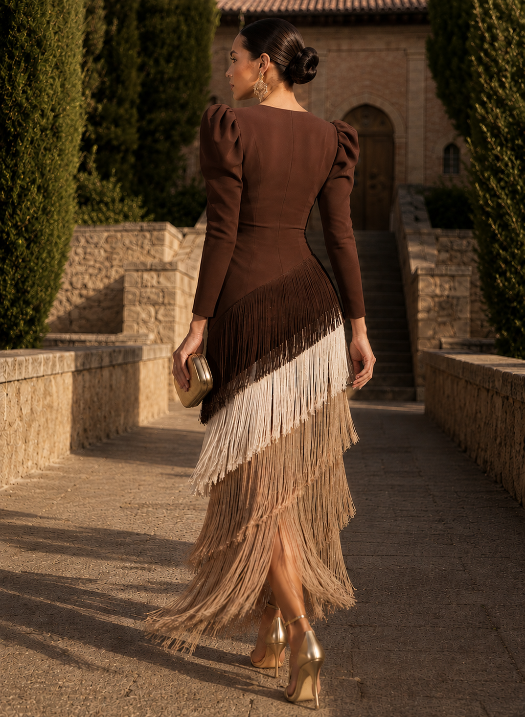 Side profile of the brown midi dress, highlighting the graceful movement of the layered fringe design.