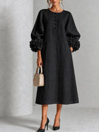 Front view of a woman wearing the white Elowen midi button dress, styled casually with sandals.