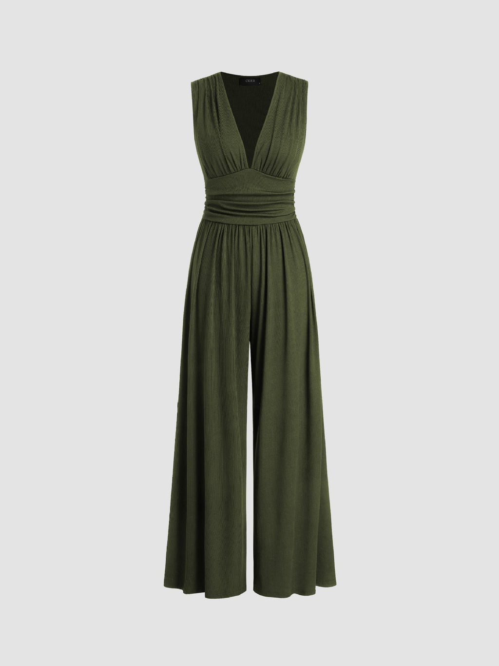 Woman gracefully posing in a navy wide-leg jumpsuit, highlighting the floor-length hem and flowing silhouette.