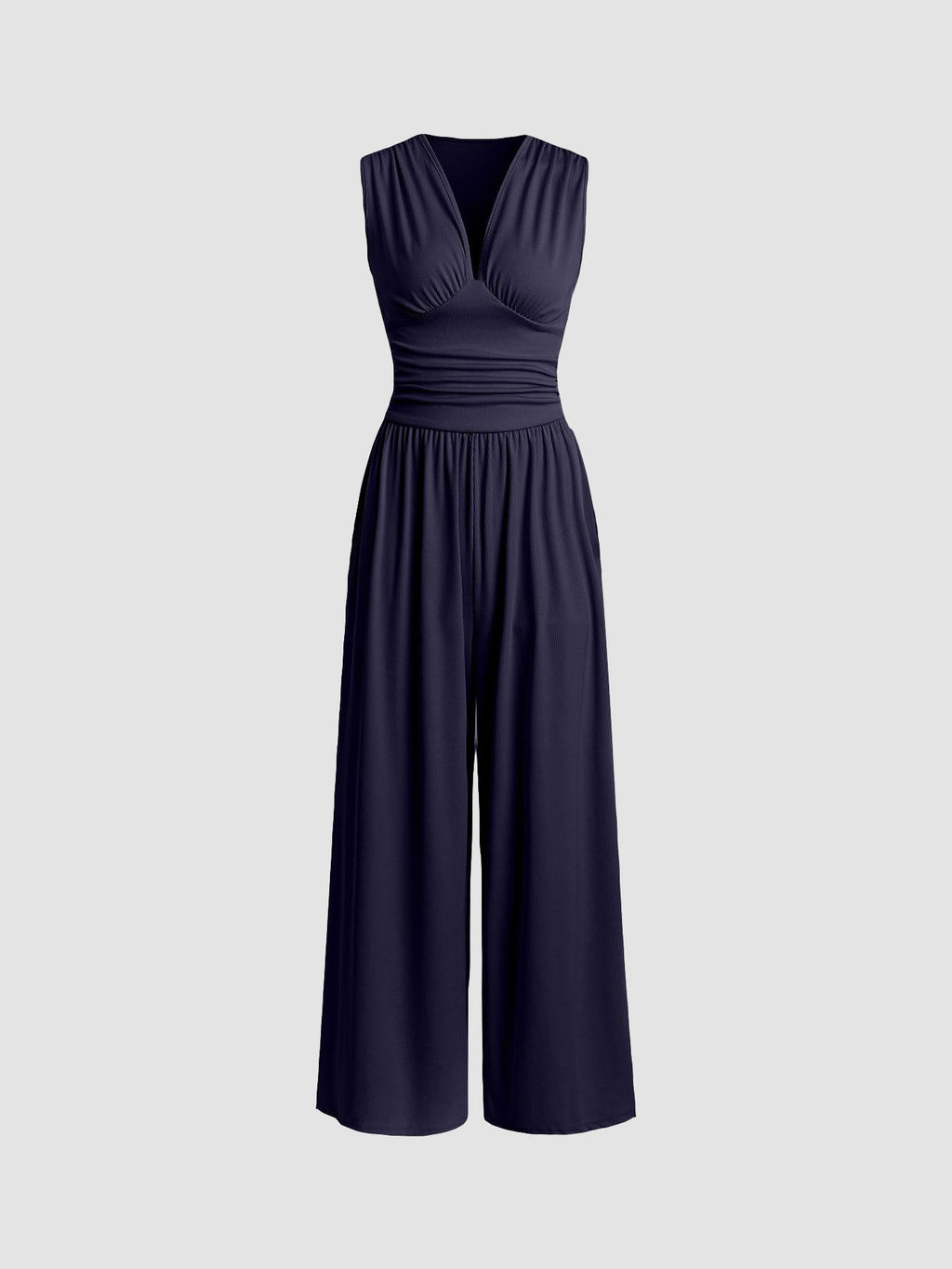 Full-length side view of the camel party jumpsuit, emphasizing the sculpted fit through the waist and relaxed trousers.