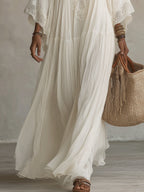 Side profile of a woman in the flowy batwing dress, emphasizing the comfortable fit and wide sleeves.