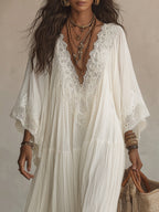 Back view of the long ivory batwing dress, highlighting its natural pleats and full, enveloping design.