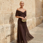 A woman confidently walking in the dark blue maxi dress, demonstrating its dramatic movement.